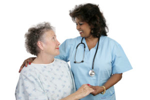 An elderly patient and a caring nurse or doctor. Isolated on white.